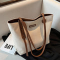Bolso de hombro de lona con detalles de piel